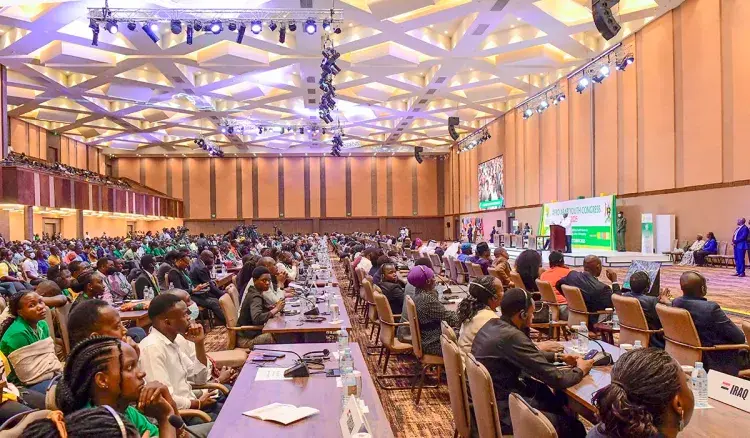 Conference delegates in Uganda receiving multilingual support including Lango / Langi